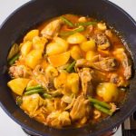 chicken pochero with vegetable over a pot