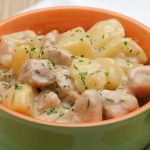 pork and potato stew in a bowl