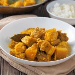 adobong dilaw with rice in a plate