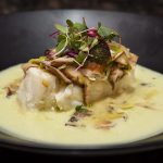 chilean sea bass on a large black bowl