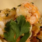 mango shrimp in a bowl with oregano on top