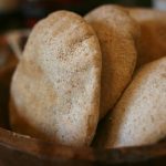pita bread in a brown wooden bowl