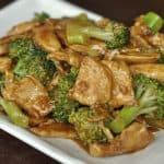 chicken and broccoli stir fry on a rectangular plate
