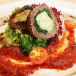 beef braciole on a plate with sauce