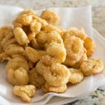 breaded shrimp with sweet and sour sauce over paper tissue