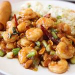 delicious kung pao shrimp with fried rice in a plate