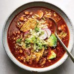 pozole rojo in a bowl with spoon