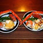 baked king crab leg on a plate with sides